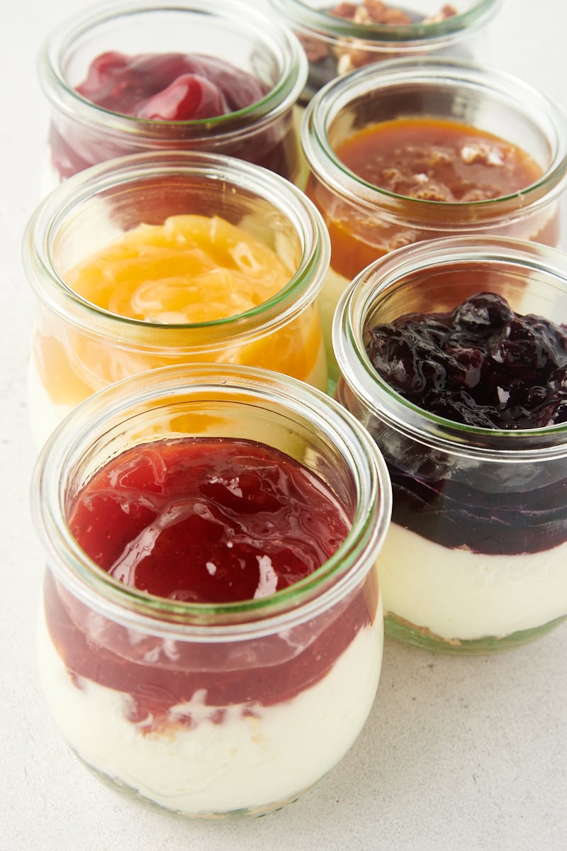 no-bake cheesecake jars on a white surface