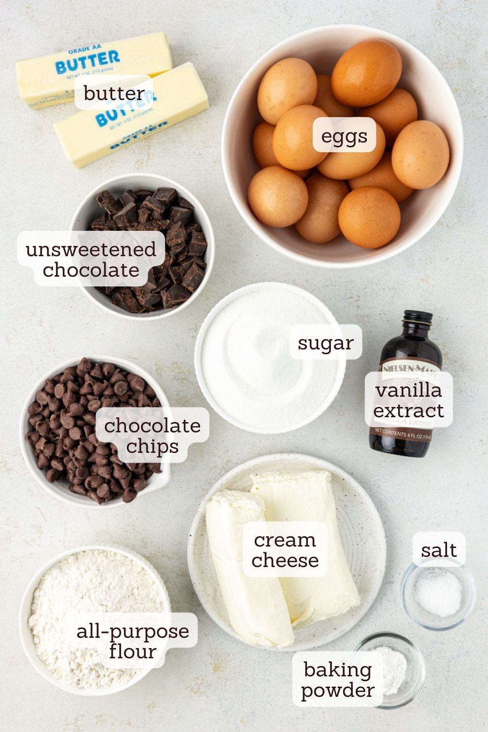 overhead view of labeled ingredients for chocolate chip cheesecake brownies