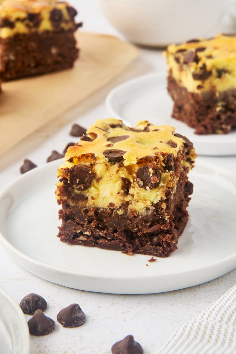 a chocolate chip cheesecake brownie on a white plate