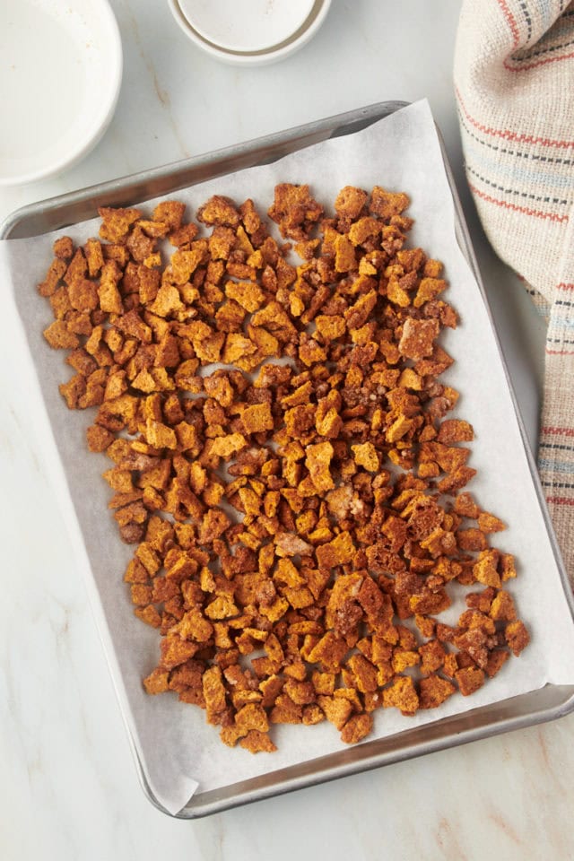 Overhead view of cinnamon bits on sheet pan