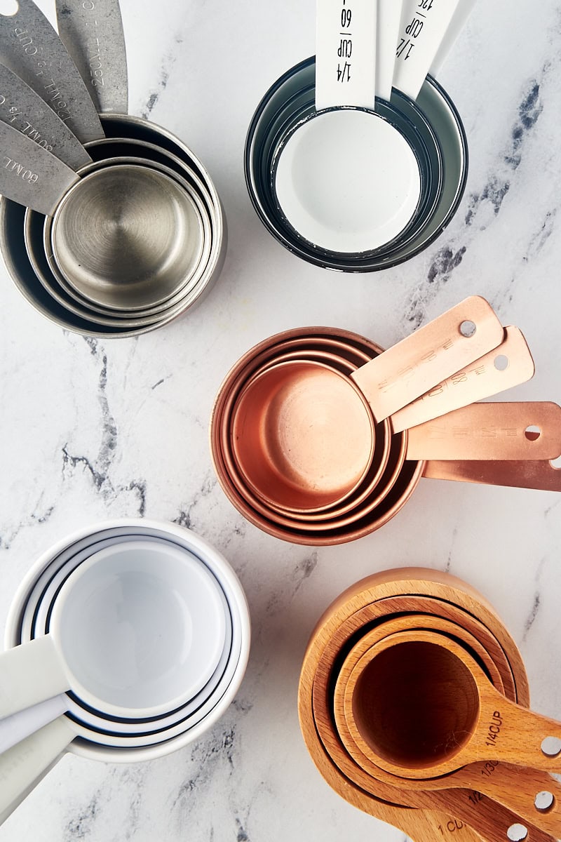 overhead view of various dry measuring cups on a marble surface