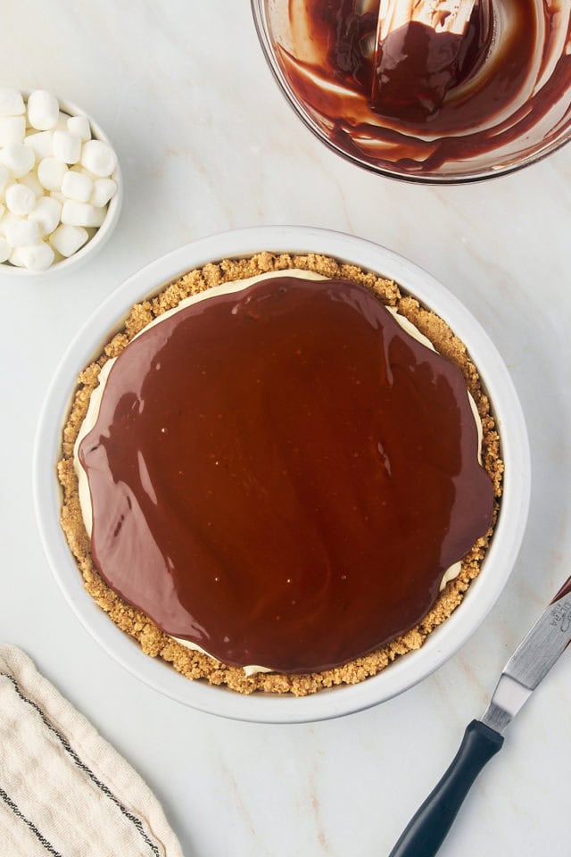 overhead view of chocolate ganache spread over s'mores pie