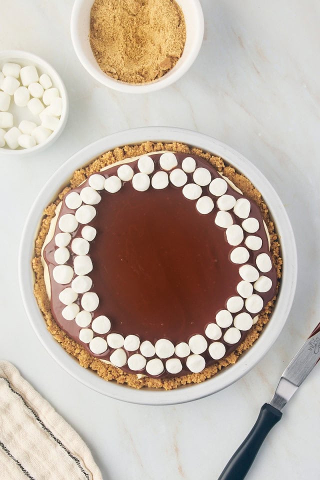 overhead view of marshmallows added to the top of s'mores pie