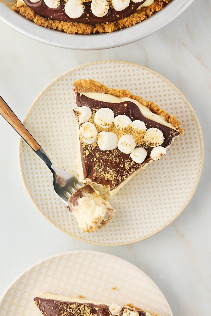 overhead view of a slice of s'mores pie with a bite on a fork