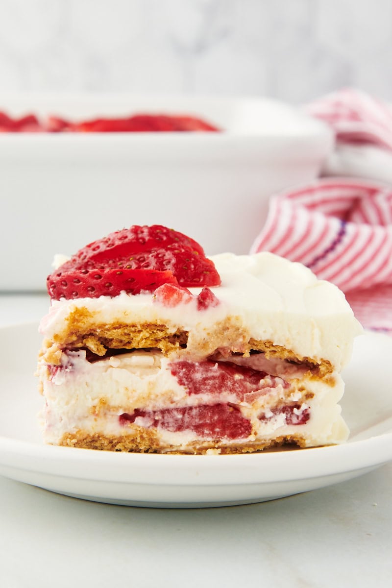 Side view of strawberry icebox cake on plate, showing layers