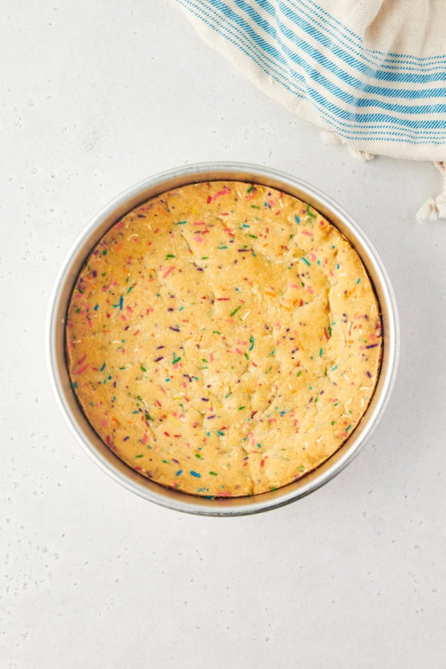 overhead view of freshly baked sugar cookie cake in a round cake pan