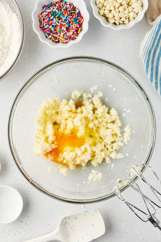 overhead view of egg and extracts added to creamed butter and sugar