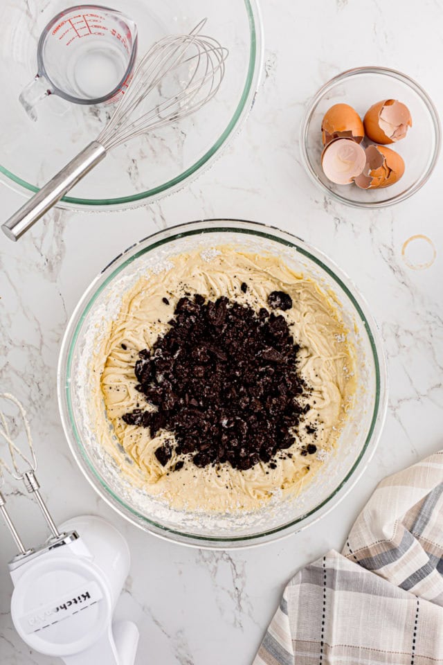 overhead view of Oreo cookie pieces added to cake batter