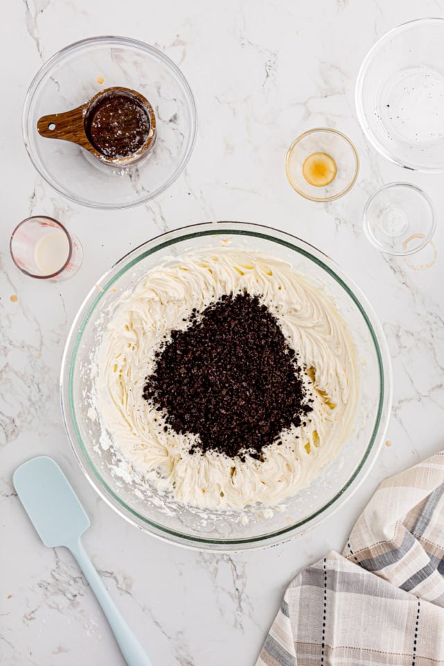 overhead view of crushed Oreos added to frosting