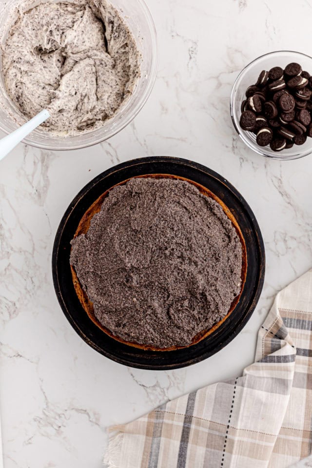 overhead view of filling spread on top of a cookies and cream cake layer