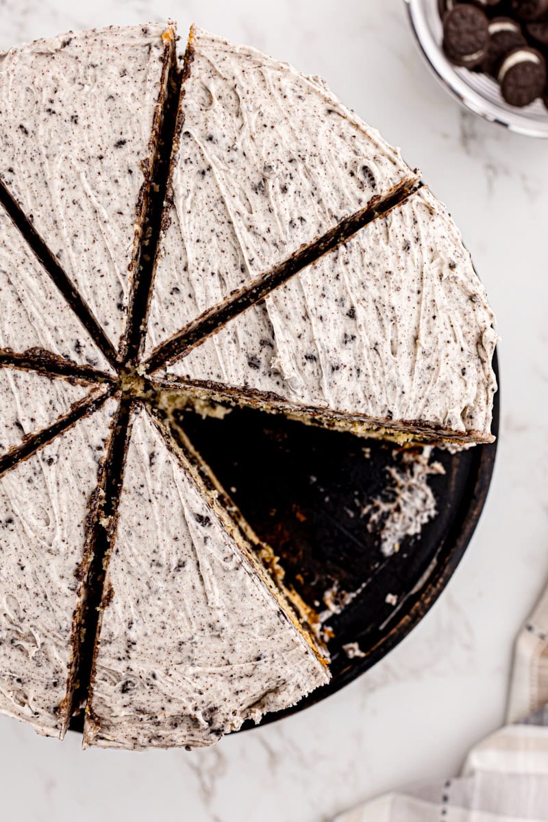 overhead view of cookies and cream cake with a slice missing