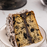 a slice of cookies and cream cake on a white plate