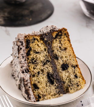 a slice of cookies and cream cake on a white plate