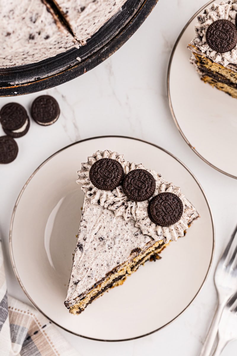 overhead view of a slice of cookies and cream cake on a white plate