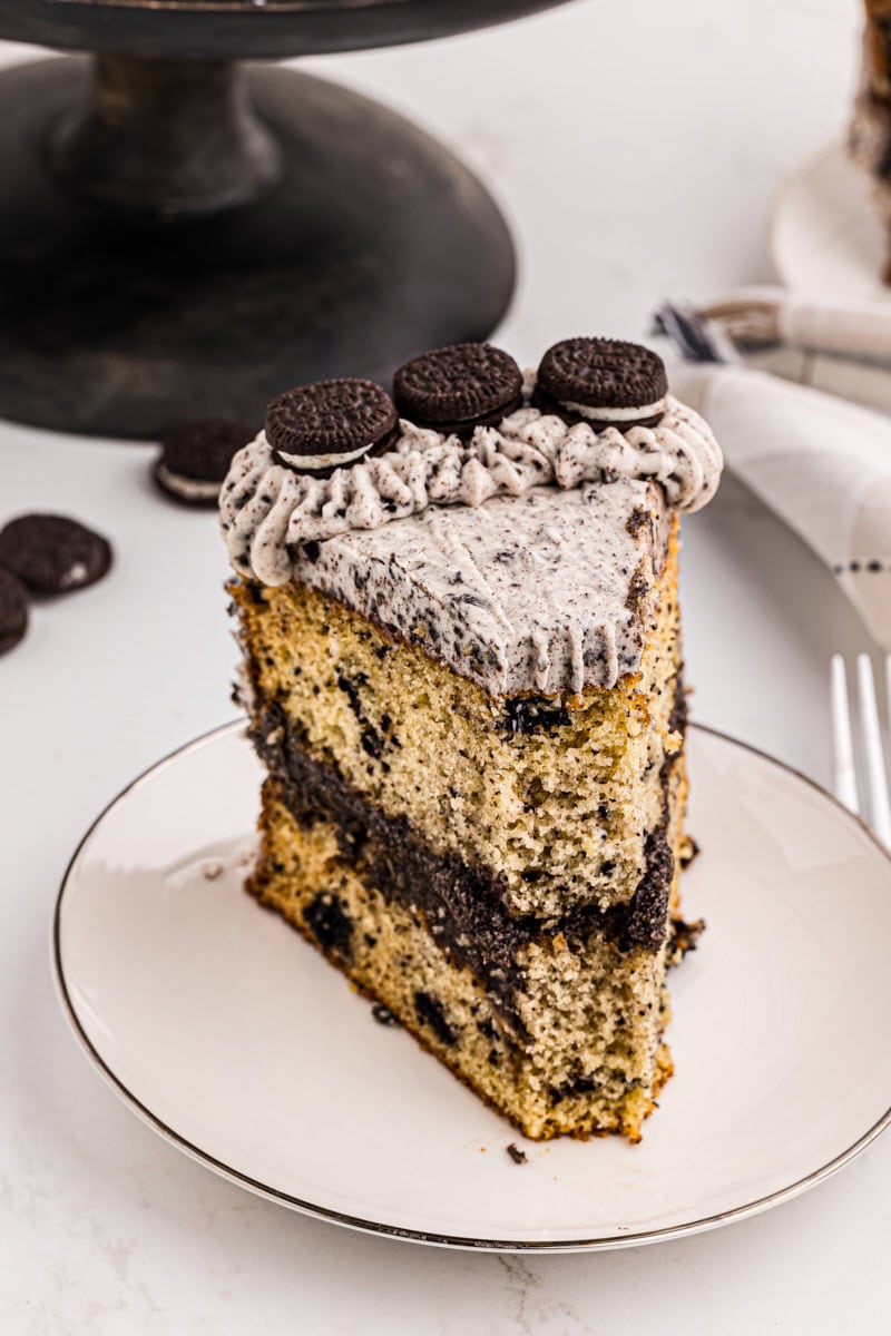 a slice of cookies and cream cake with a bite missing