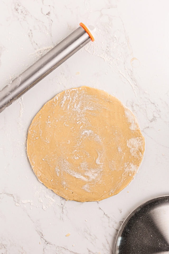 overhead view of rolled sugar cookie crust dough for fruit pizza