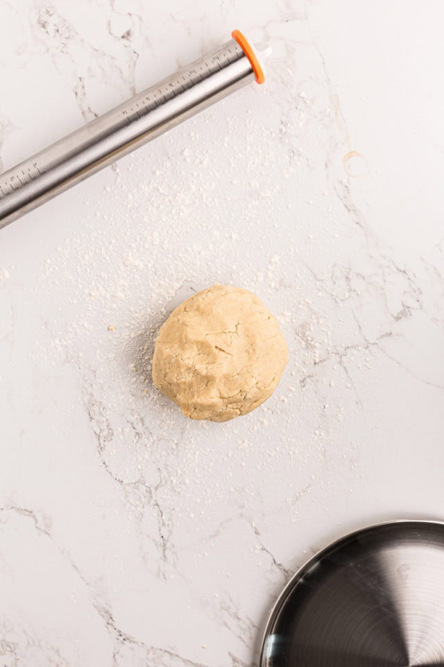 overhead view of sugar cookie crust dough on a floured surface