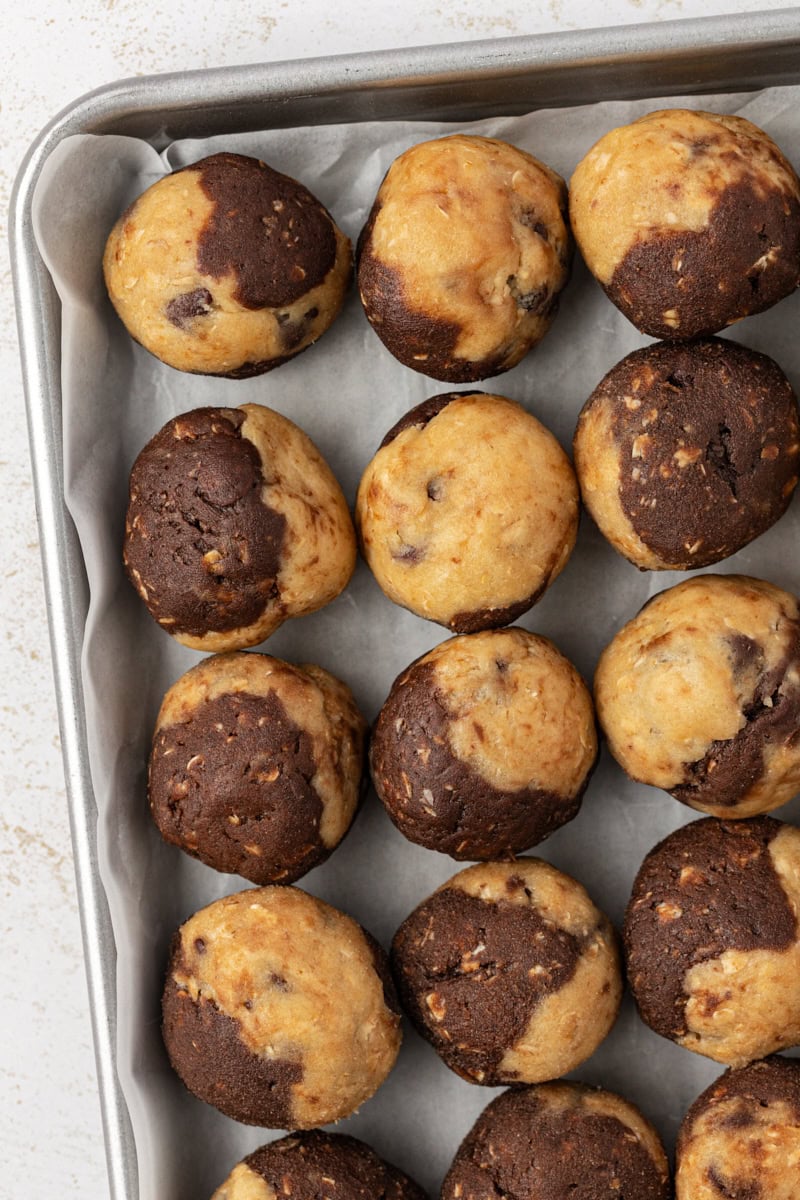 overhead view of marbled chocolate chip cookie dough on a baking sheet