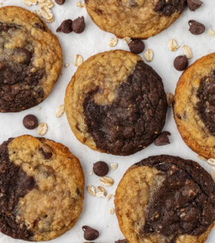 overhead view of marbled chocolate chip cookies on a white and beige countertop