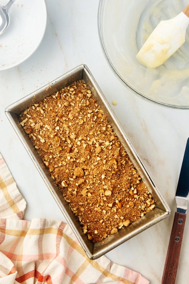 overhead view of remaining cinnamon swirl mixture added to quick bread batter in a loaf pan