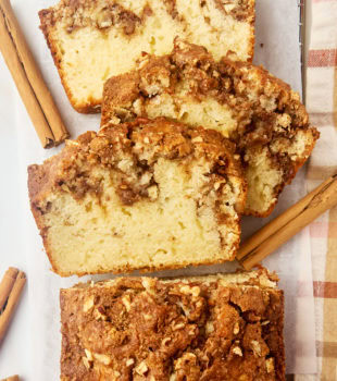 overhead view of partially sliced cinnamon swirl bread on parchment paper