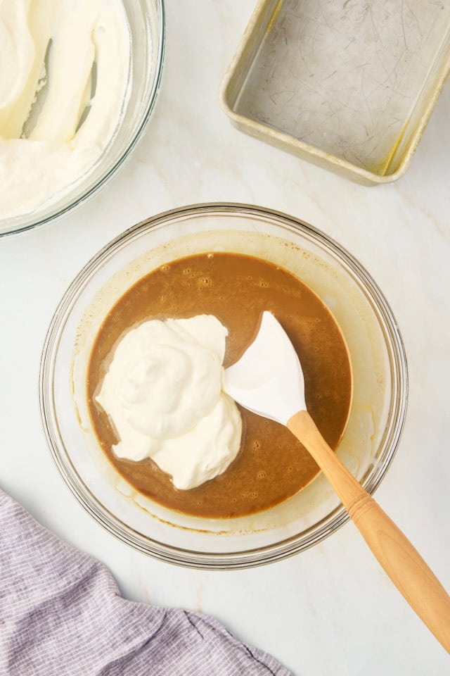 overhead view of whipped cream added to coffee ice cream mixture