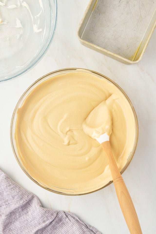 overhead view of mixed coffee ice cream mixture in a glass mixing bowl