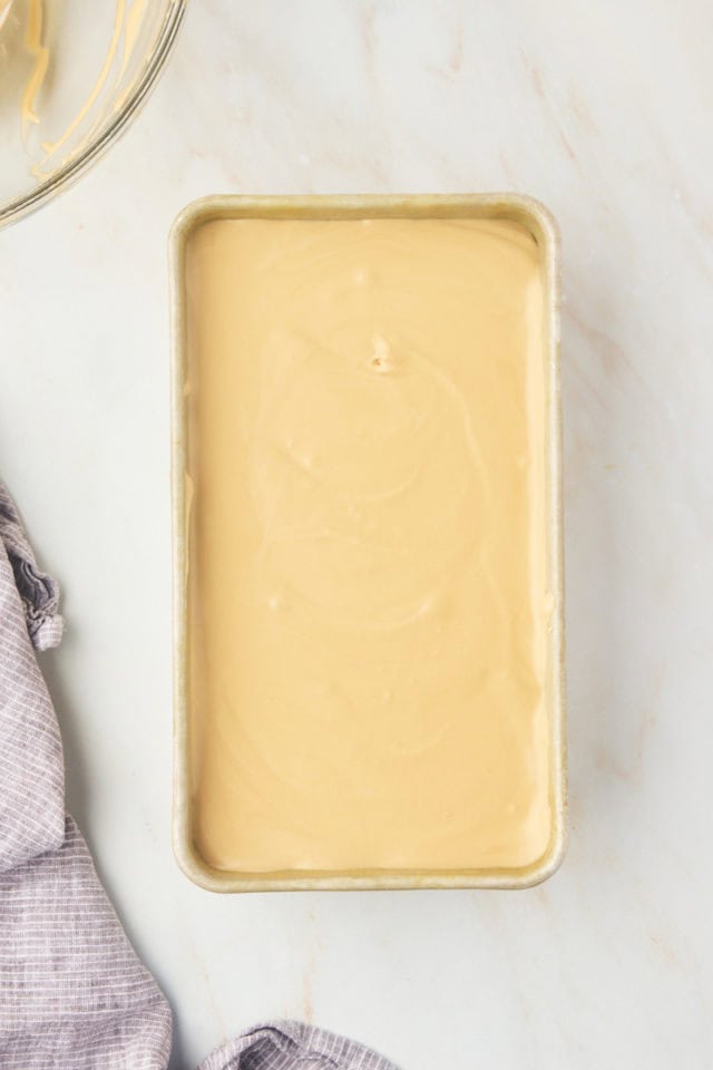 overhead view of coffee ice cream in a metal loaf pan ready to go into the freezer