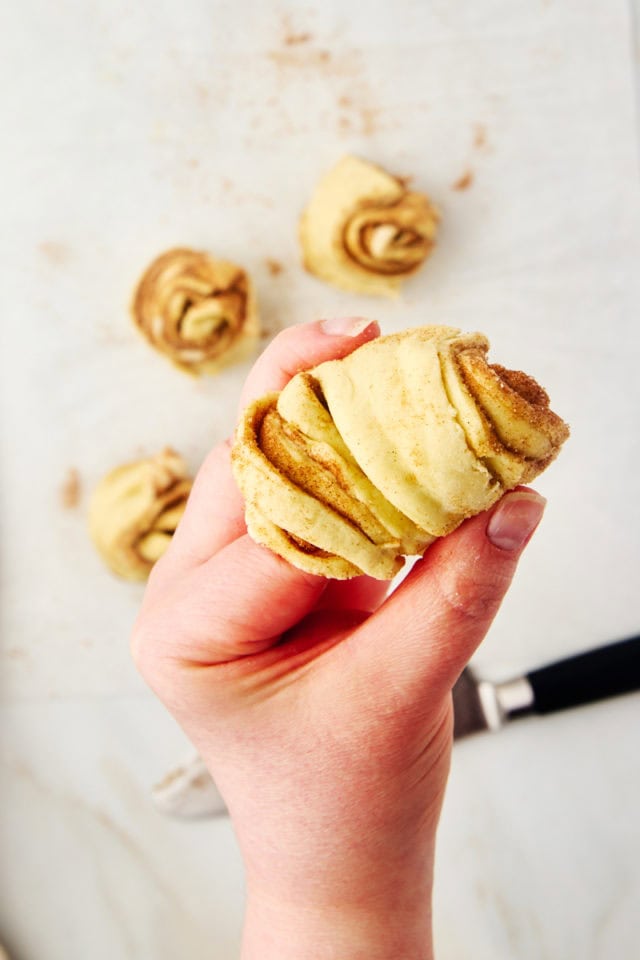 cruffin dough wrapped around a finger for shaping