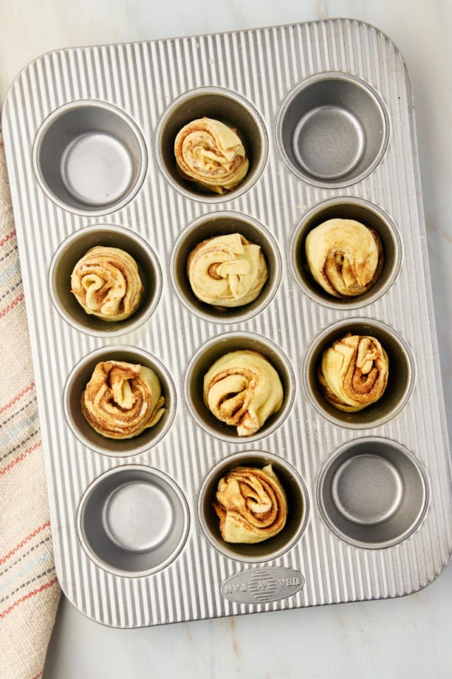 overhead view of cruffins in a muffin pan ready to go into the oven