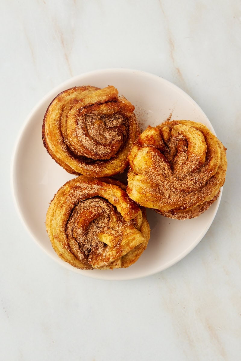 overhead view of three cruffins on a white plate