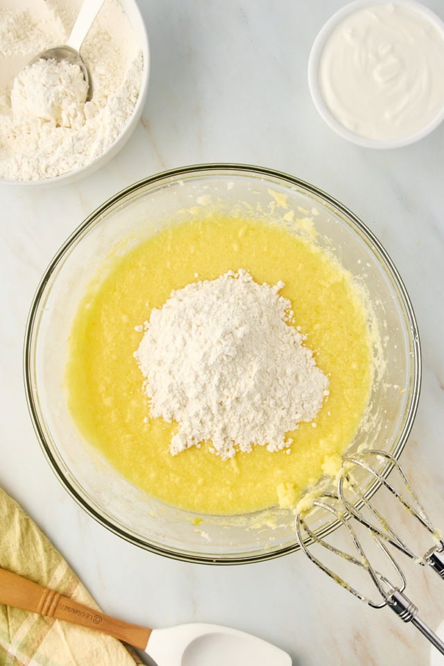 Dry ingredients added to cake batter in mixing bowl