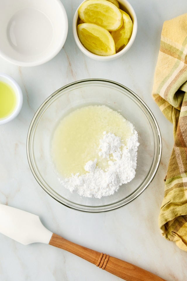 Overhead view of ingredients for limoncello cake glaze in bowl