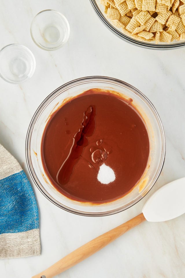 overhead view of vanilla extract and salt added to melted chocolate, peanut butter, and butter