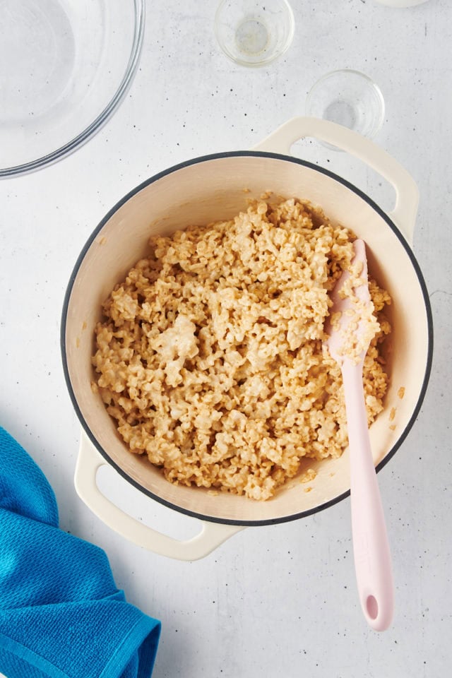 overhead view of cereal stirred into marshmallow mixture for rice crispy treats