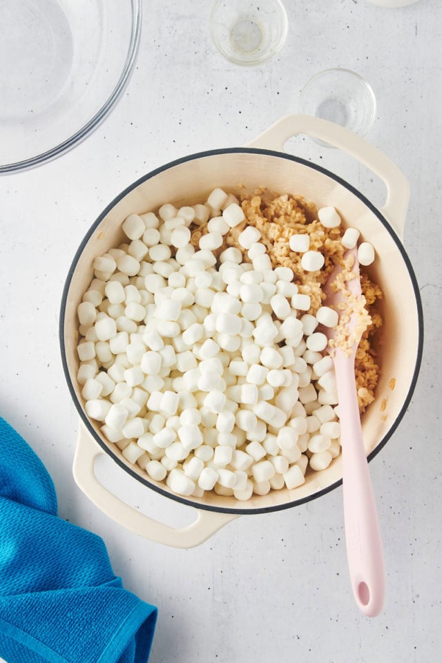 overhead view of more marshmallows added to rice crispy treats mixture