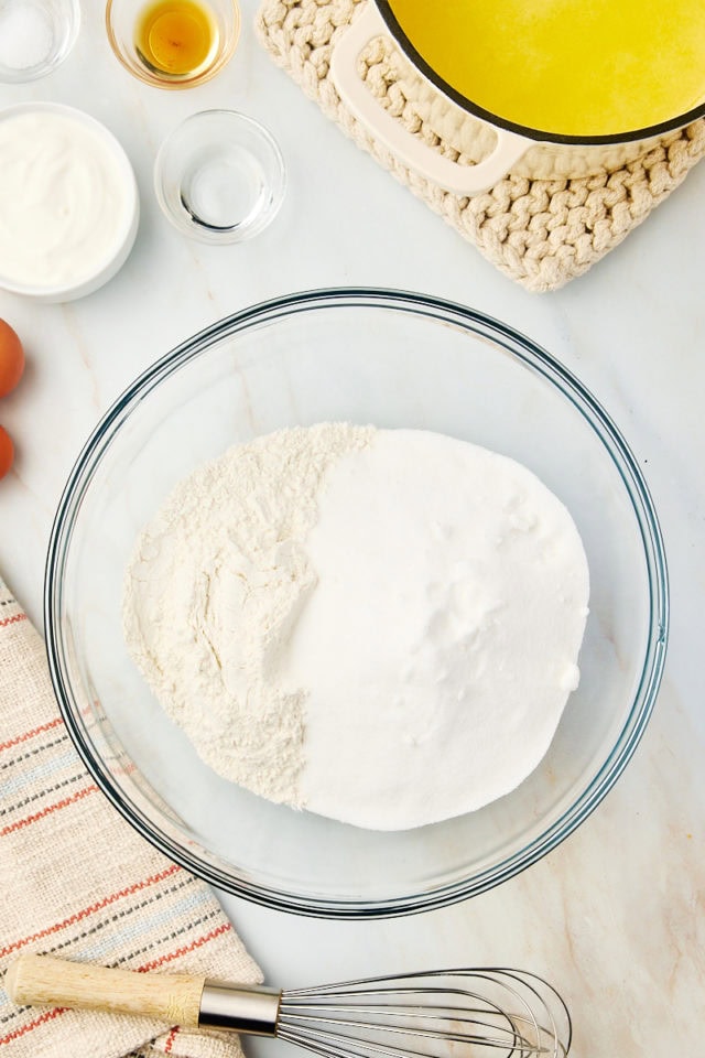 overhead view of flour and sugar in a mixing bowl