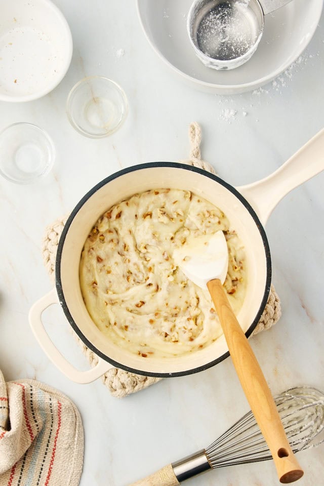 overhead view of mixed white Texas sheet cake frosting in a saucepan