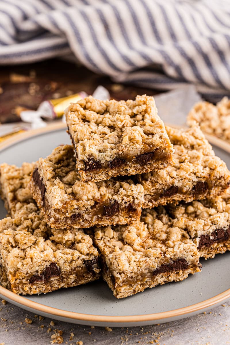 caramel oatmeal bars stacked on a plate