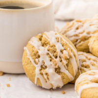 a coffee cake cookie propped against a coffee mug