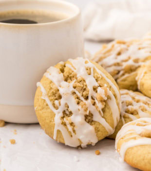 a coffee cake cookie propped against a coffee mug