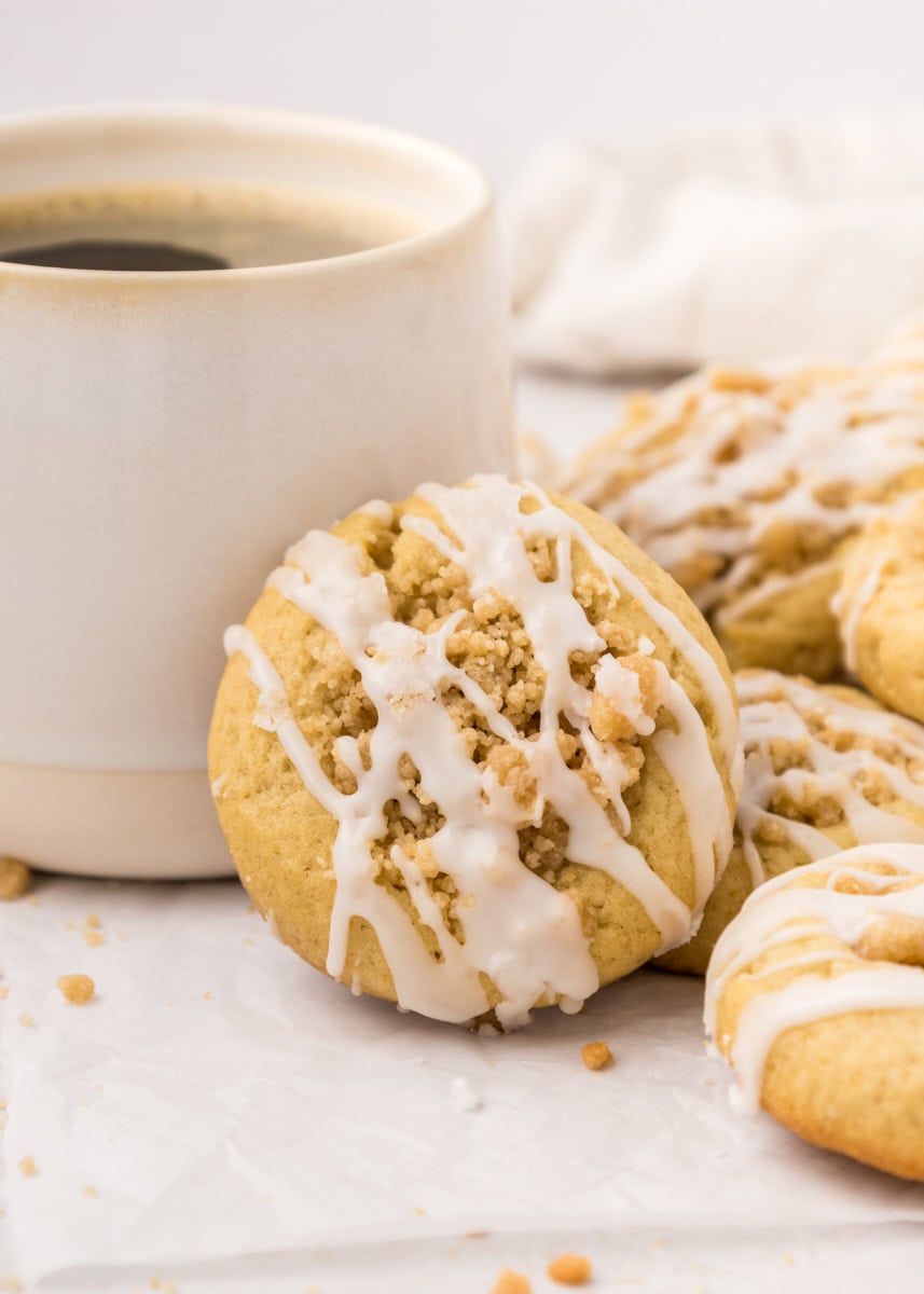 a coffee cake cookie propped against a coffee mug