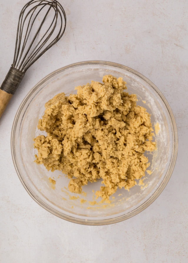 overhead view of coffee cake cookie dough in a glass mixing bowl