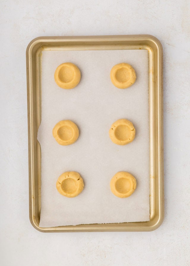 overhead view of portioned coffee cake cookie dough with indentations made in the center of each