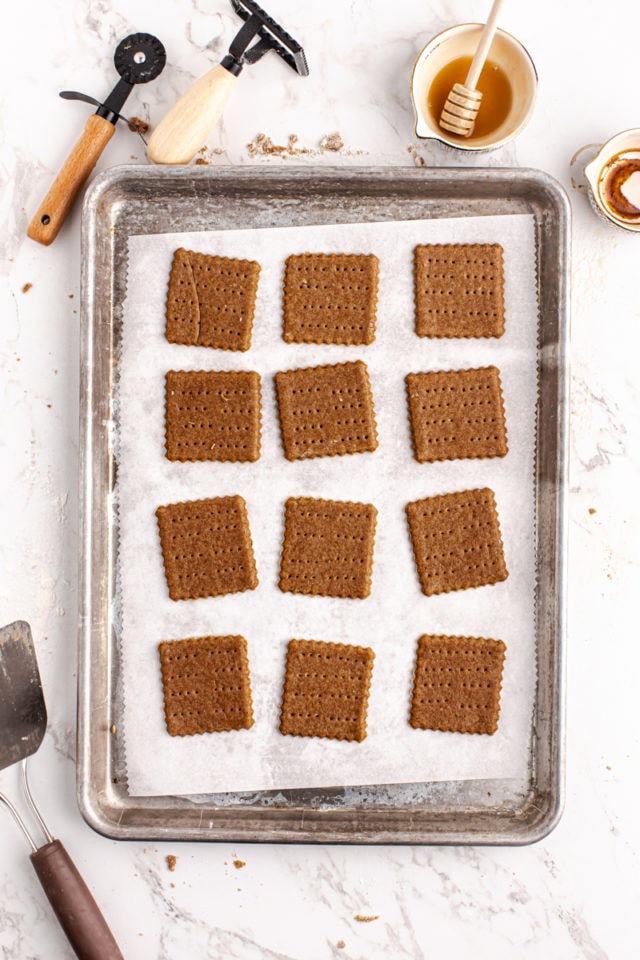 overhead view of homemade graham crackers on a baking pan ready to go into the oven