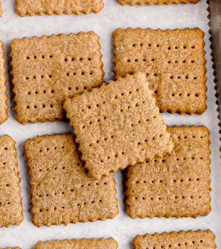 overhead view of homemade graham crackers on a baking sheet