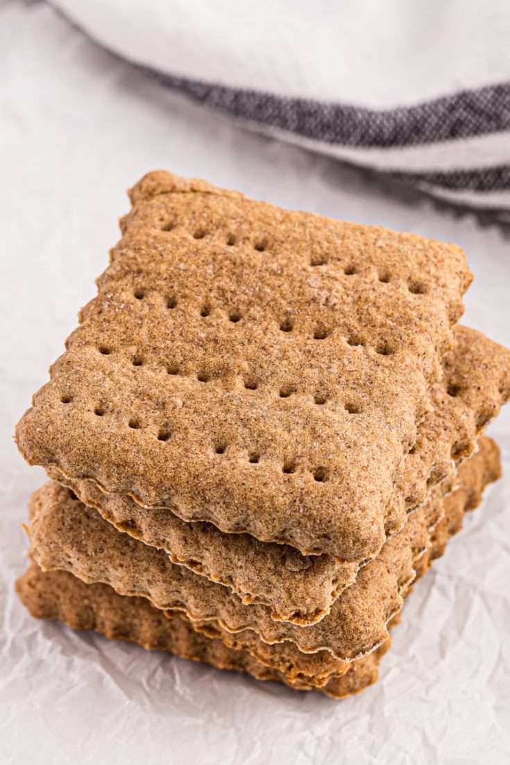 stack of homemade graham crackers on parchment paper