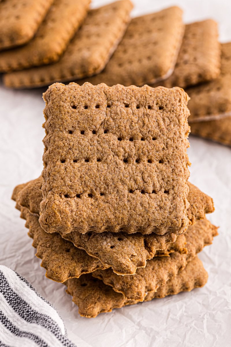 stack of homemade graham crackers on parchment paper