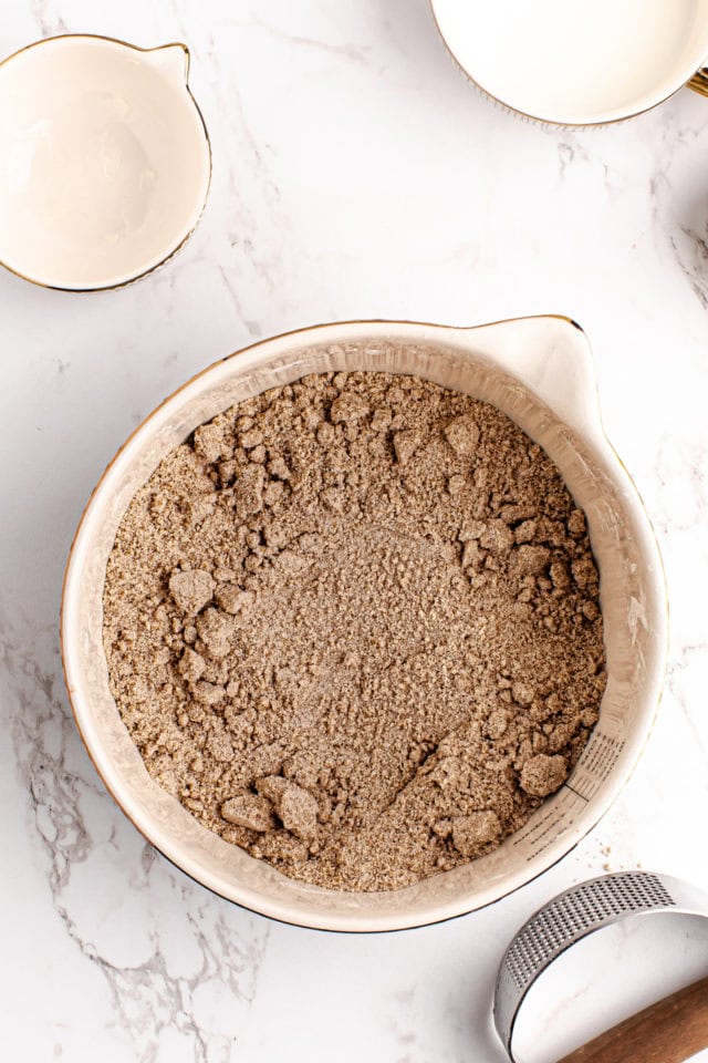 overhead view of mixed dry ingredients and butter for homemade graham crackers