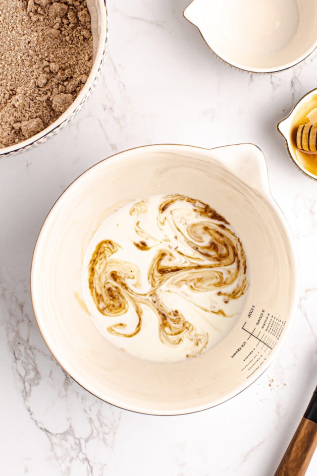 overhead view of wet ingredients for homemade graham crackers in a mixing bowl